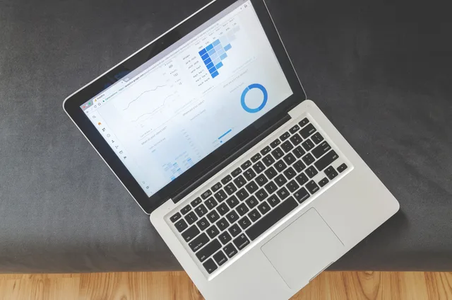 Overhead view of a laptop showing data visualizations and charts on its screen. Customer data platform teams in North West England: roles and governance
