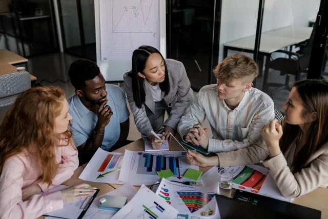 Diverse group of colleagues brainstorming and discussing strategy in a modern office setting. Customer data platforms buyer personas: research method