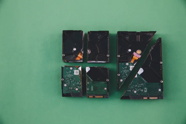 Four broken hard drives arranged on a green background, showcasing data destruction. Customer data platform objections: a direct-marketing suppression runbook