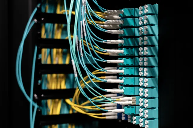 Closeup of electronic device with colorful wires installed in rows in communications room on blurred background in dark studio inside. How to audit a customer data platform's consent trail before renewal